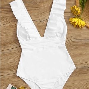 Never worn, white ruffle trim lace back one piece